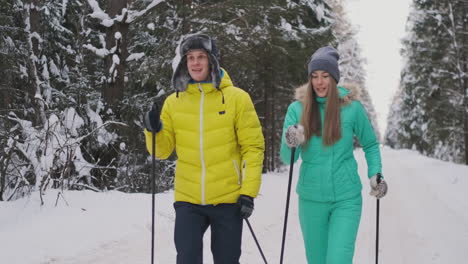 Slow-motion-shot-of-a-loving-couple-skiing-in-the-woods-on-the-eve-of-Valentine's-day